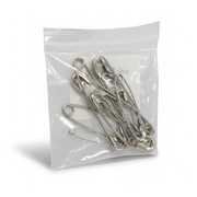 Clear resealable bag containing Safety Pins (Assorted Sizes) - Pack of 12 for first aid and bandage securing.
