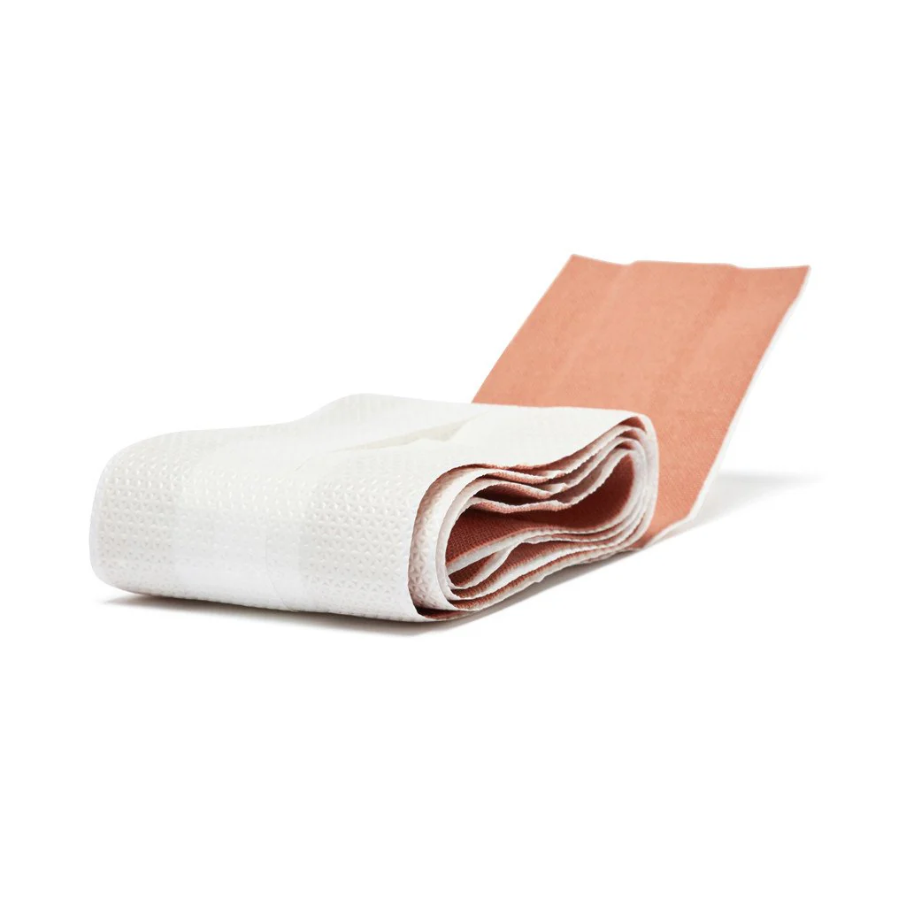 Coverplast Dressing showing strong adhesive elastic fabric designed for durable protection in first aid supplies.