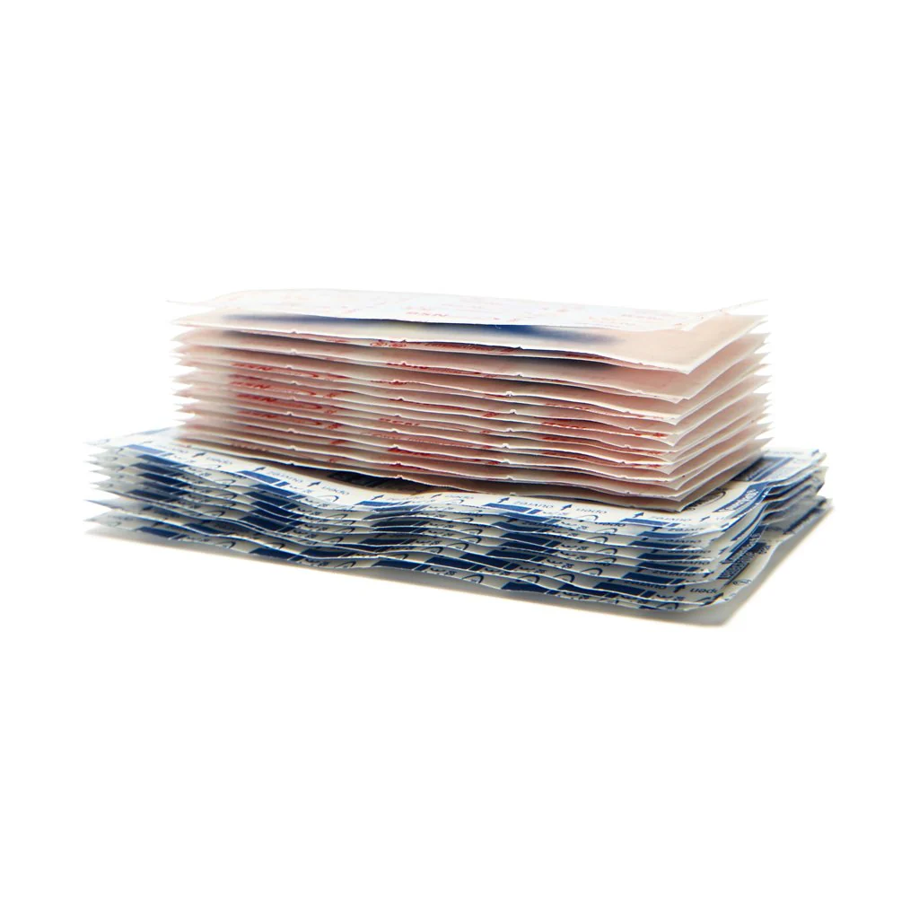 Stacked individually wrapped Leukoplast Detectable Dressing showing blue and white packaging for food industry use and first aid supplies.