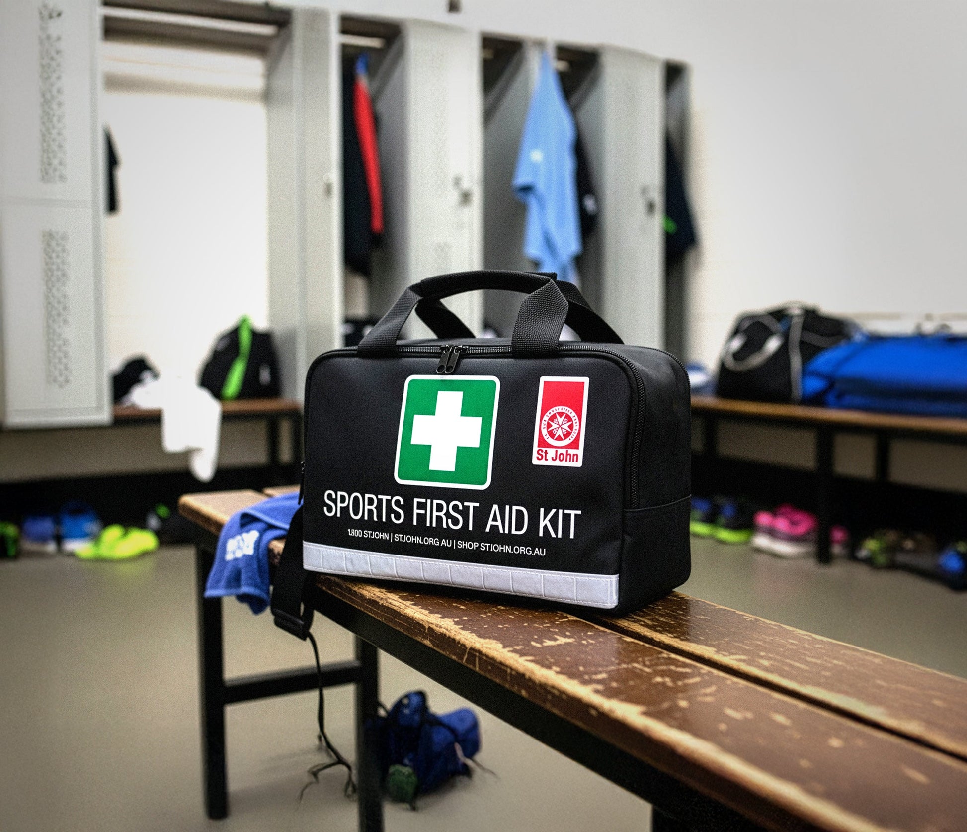 Sports First Aid Kit bag on a bench in a locker room, ready for immediate care during sports activities