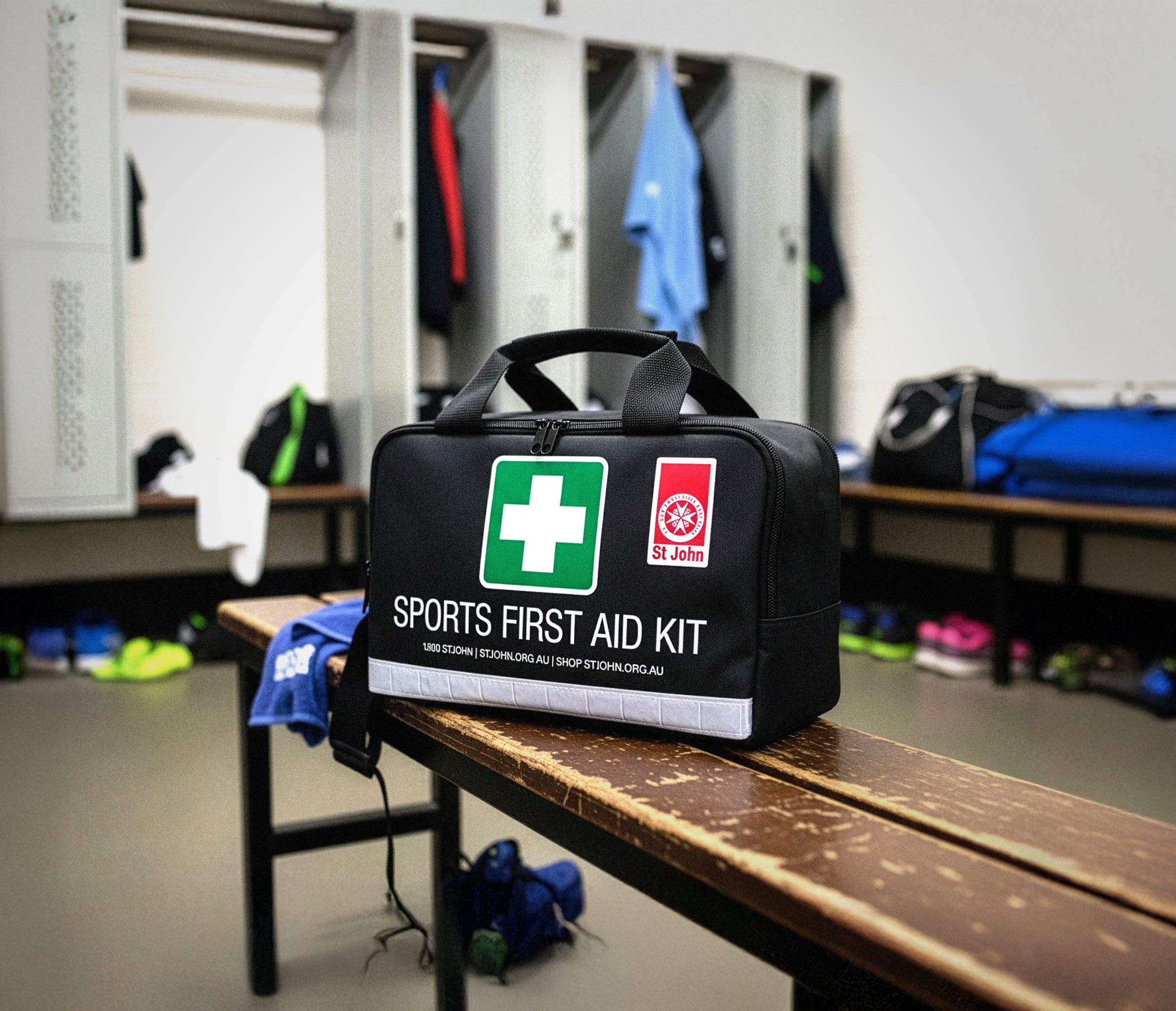 Sports First Aid Kit bag on a bench in a locker room, ready for immediate care during sports activities